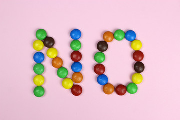 Word no of multicolored candies on pink background