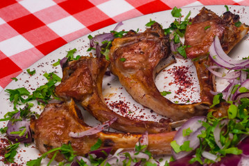 Rack of Lamb served with onion and green vegetables