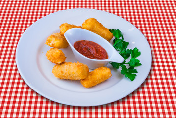 Fried mozzarella cheese sticks with red sauce