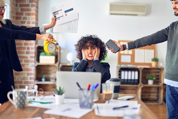 Group of business workers working together. Partners stressing one of them at the office