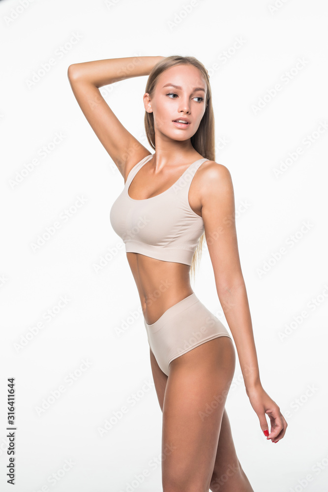 Wall mural Slim tanned woman in beige underwear isolated over white background. Healthy lifestyles concept.