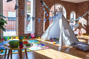 Picture of preschool playroom with colorful furniture and toys around empty kindergarten © Krakenimages.com