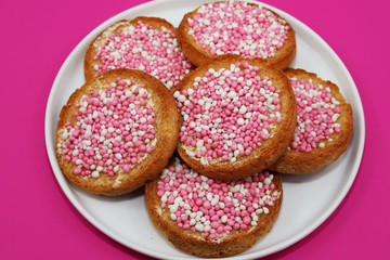 Rusk with pink and white anise seeds.  Traditional Dutch treat to celebrate the birth of baby girl.