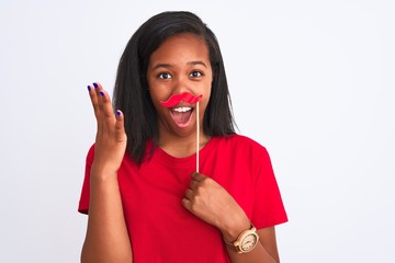 Young african american woman wearing vintage pretend mustache over isolated background very happy...
