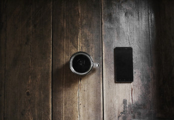 Smartphone and a cup of coffee , top view.