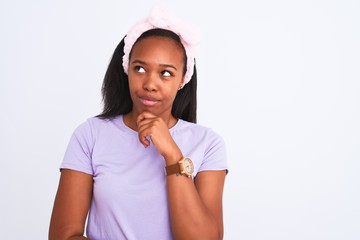 Beautiful young african american woman wearing a beauty diadem over isolated background serious face thinking about question, very confused idea