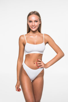 Young woman with beautiful slim perfect body in white bikini isolated white background