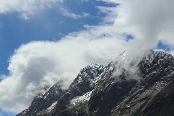 Clouds and mountains of the fjordland, Milford Sound, New Zealand, South Island