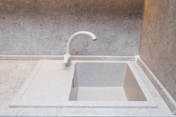 Ceramic sink with tap in the new kitchen.