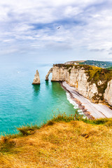 Fototapeta na wymiar Panorama of natural chalk cliffs of Etretat with visible arche and beach coastline, Normandy, France, Europe