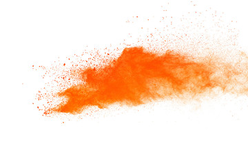 Abstract orange powder explosion. Closeup of orange dust particle splash isolated on white background.