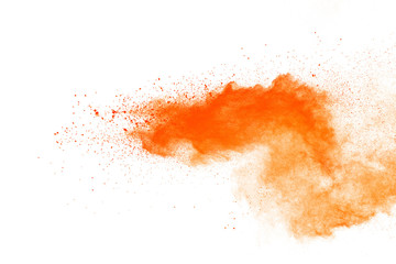Abstract orange powder explosion. Closeup of orange dust particle splash isolated on white background.