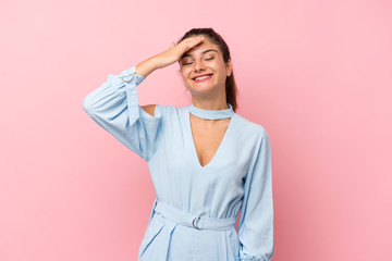 Young brunette girl over isolated pink background laughing