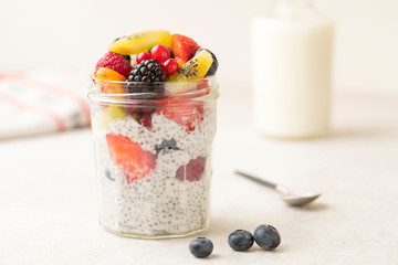 Chia seeds yoghurt and fruits breakfast in a glass jar