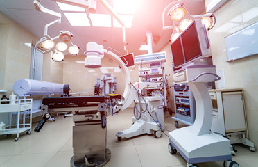 Clinic interior with operating surgery table, lamps and ultra modern devices, technology, hi-tech...