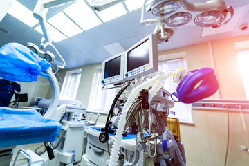 Establishing shot of technologically advanced operating room with no people, ready for surgery....