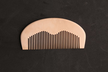 wooden comb in color background