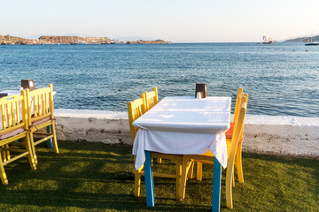 Tables in Bodrum town near beautiful Aegean Sea. Beach cafe near  sea, Turkey.  Sunset.