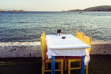 Tables in Bodrum town near beautiful Aegean Sea. Beach cafe near  sea, Turkey.  Sunset.