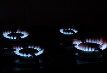 burning gas stand comforts on a stove on a black background. Concept - gas wars, shale gas, cook...