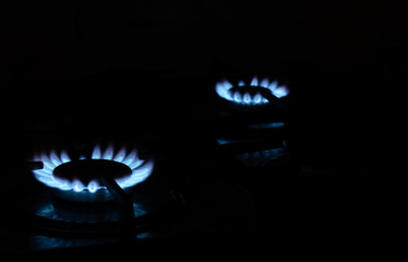 burning gas stand comforts on a stove on a black background. Concept - gas wars, shale gas, cook...