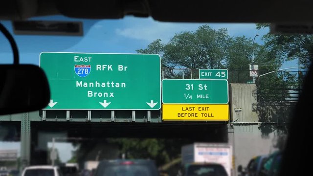 Driving On Grand Central Parkway From LaGuardia Airport To Queens, New York City, USA. Number Plates And Car Logos Defocused.