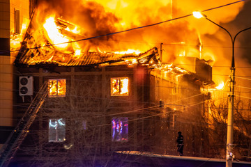 firefighters extinguish burning house in the dark, Burning building in Samara, Russia