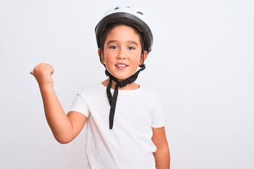Beautiful kid boy wearing bike security helmet standing over isolated white background smiling with happy face looking and pointing to the side with thumb up.