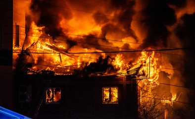 firefighters extinguish burning house in the dark, Burning building in Samara, Russia