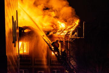 firefighters extinguish burning house in the dark, Burning building in Samara, Russia