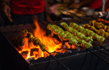 Street food/Traditional Grilled tandoori of  assorted meats with charcoal and fire on skewers