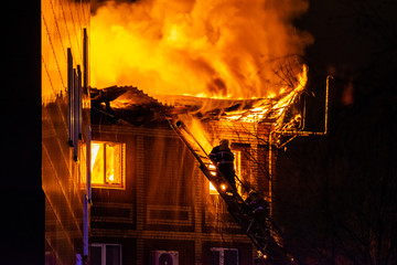 firefighters extinguish burning house in the dark, Burning building in Samara, Russia