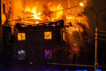 firefighters extinguish burning house in the dark, Burning building in Samara, Russia