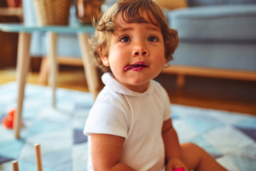 Fototapeta premium Beautiful toddler child girl playing with toys on the carpet