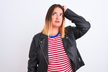 Young beautiful woman wearing striped shirt and jacket over isolated white background confuse and wonder about question. Uncertain with doubt, thinking with hand on head. Pensive concept.