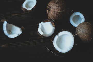 coconuts on a dark table and green leaf shaped plate\ small field of depth