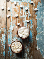 Cappuccino with marshmallows in a cup on an old wooden background. New Year's still life
