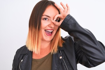 Young beautiful woman wearing t-shirt and jacket standing over isolated white background with happy face smiling doing ok sign with hand on eye looking through fingers