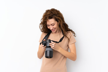 Young pretty woman over isolated background with a professional camera