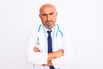 Fototapeta premium Middle age doctor man wearing stethoscope and tie standing over isolated white background skeptic and nervous, disapproving expression on face with crossed arms. Negative person.