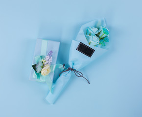 gift bouquet with blue roses on a blue background