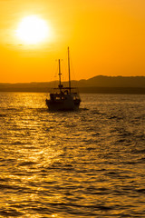 Fototapeta premium Sunset at sea. toned. Yacht in the sunset. copy space. vertical pgoto