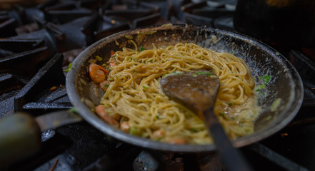 Shrimp Alfredo pasta in a blue plate  