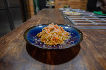 Shrimp Alfredo pasta in a blue plate  