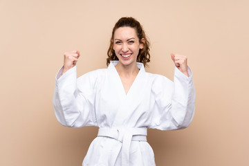 Young woman doing karate celebrating a victory