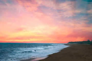 Naklejka na ściany i meble beautiful sunset on the beach with reddish sun
