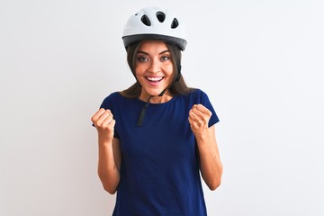 Young beautiful cyclist woman wearing security bike helmet over isolated white background celebrating surprised and amazed for success with arms raised and open eyes. Winner concept.
