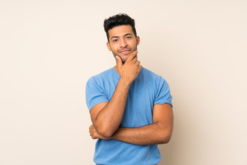 Young handsome man over isolated background thinking