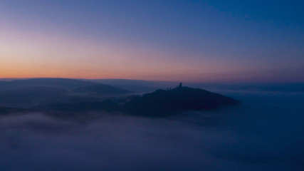 to the blue hour view over the fog on the castle ruin murach just before sunrise 
