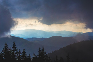 Thick dark clouds covered the mountains. Mountains before a thunderstorm_